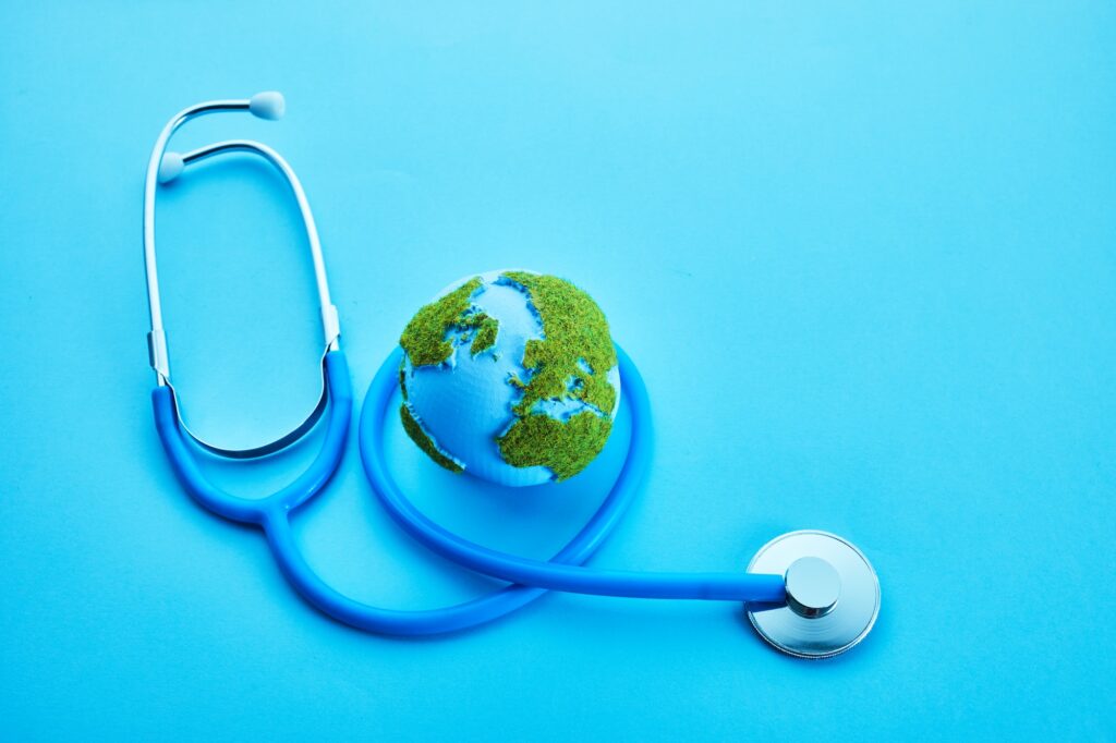 World Health Day. Global Health Awareness Concept. Globe and Stethoscope on blue background.